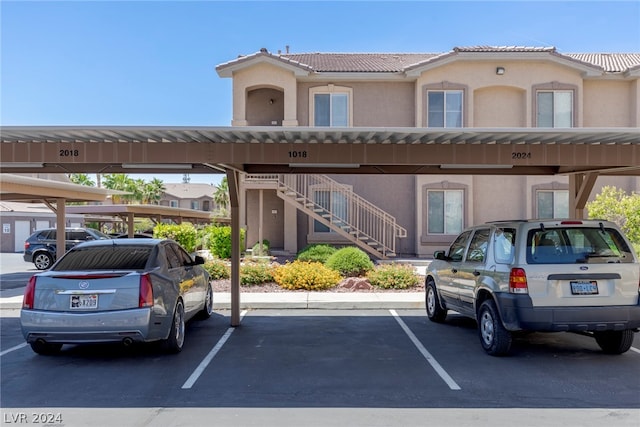 view of parking / parking lot featuring a carport