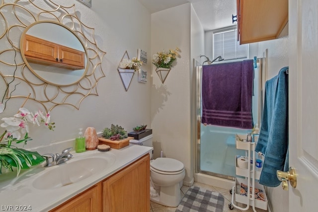 bathroom with walk in shower, oversized vanity, toilet, and tile floors