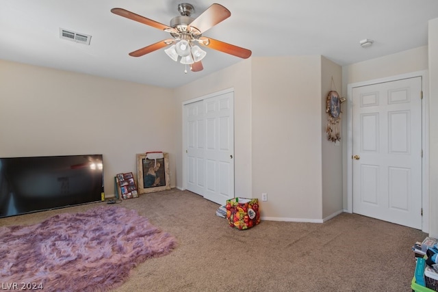 game room with carpet flooring and ceiling fan