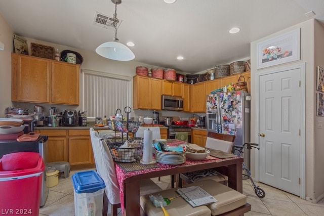 kitchen with light tile floors, pendant lighting, and appliances with stainless steel finishes