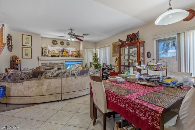 tiled dining area with ceiling fan