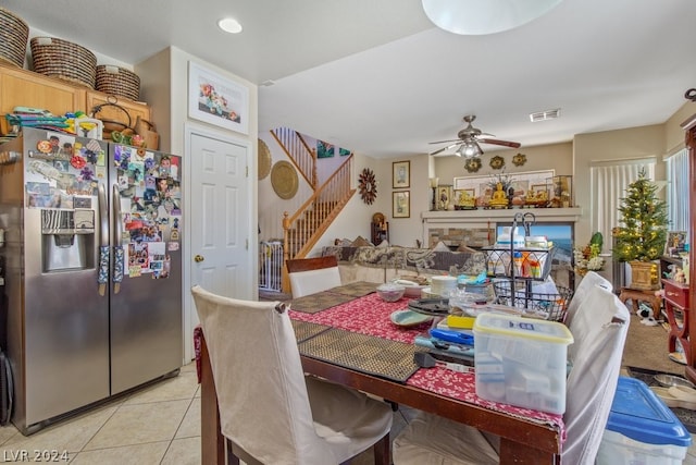 tiled dining area featuring ceiling fan