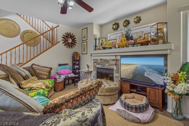 living room featuring ceiling fan, carpet floors, and a fireplace