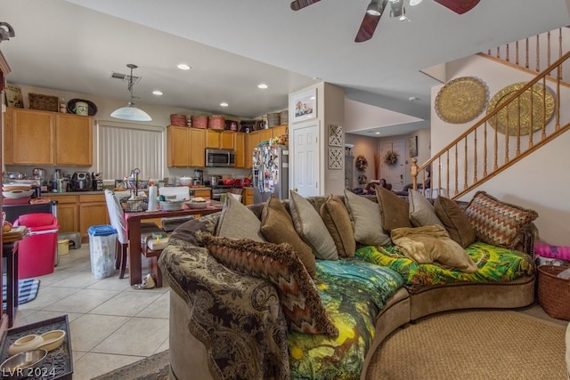 living room featuring ceiling fan and light tile floors