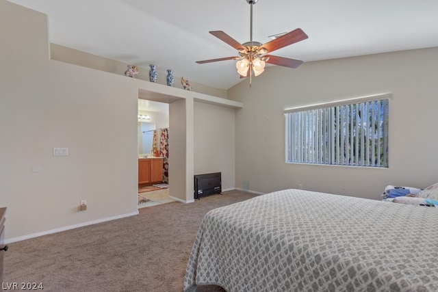 bedroom with carpet flooring, ceiling fan, vaulted ceiling, and ensuite bath