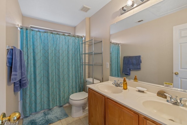 bathroom with dual sinks, tile flooring, toilet, and large vanity