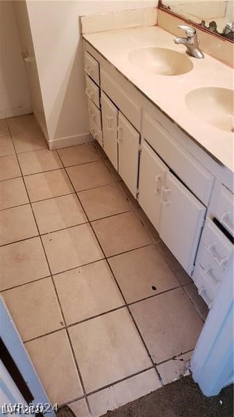 bathroom featuring dual bowl vanity and tile floors