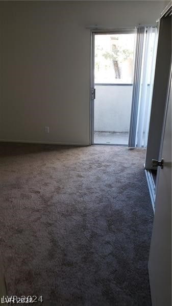 empty room featuring dark colored carpet