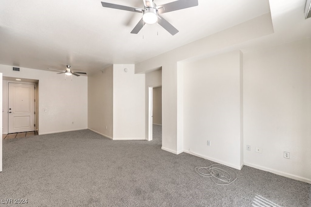 unfurnished room with ceiling fan and carpet flooring