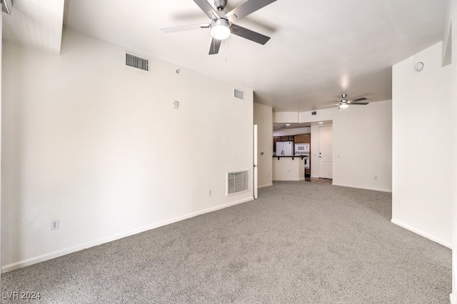 empty room with ceiling fan and carpet