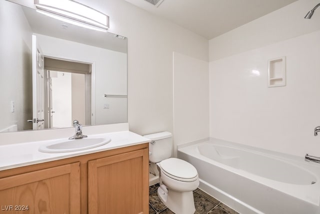 bathroom featuring toilet, vanity, and a bath