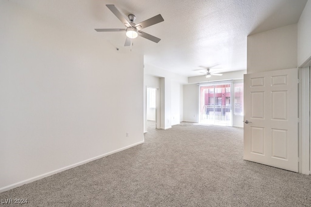 unfurnished room with ceiling fan, carpet floors, and a textured ceiling