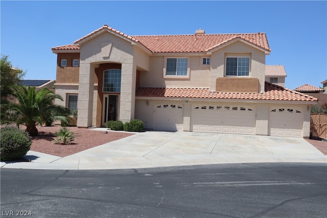 mediterranean / spanish-style house featuring a garage