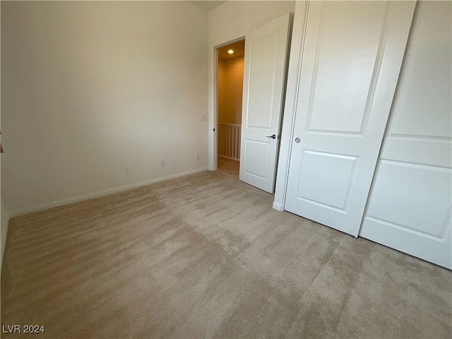 unfurnished bedroom featuring light colored carpet