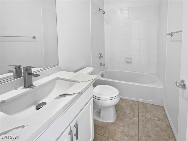 full bathroom featuring tile patterned floors, toilet, tiled shower / bath combo, and vanity