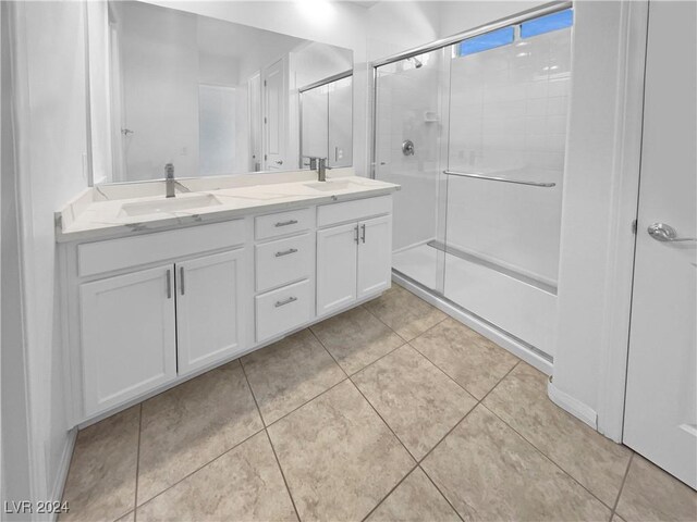 bathroom with tile patterned flooring, an enclosed shower, and vanity