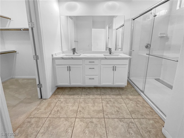 bathroom featuring vanity, walk in shower, and tile patterned flooring