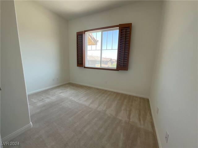 empty room featuring light carpet