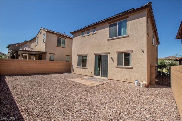 rear view of property featuring a patio