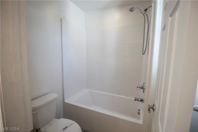 bathroom featuring tiled shower / bath combo and toilet