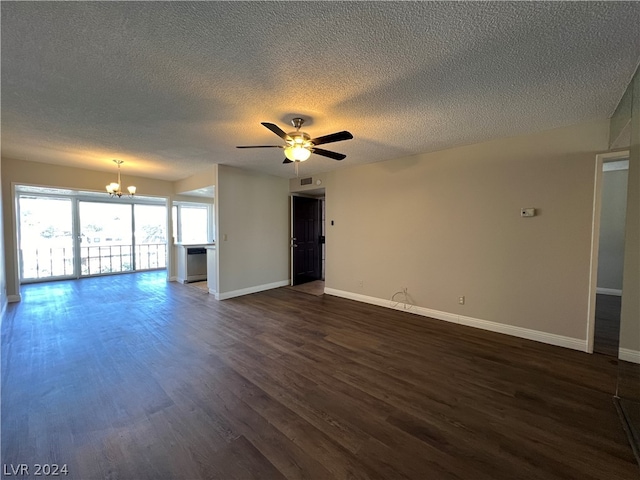 unfurnished living room featuring ceiling fan with notable chandelier, a textured ceiling, and dark wood-type flooring