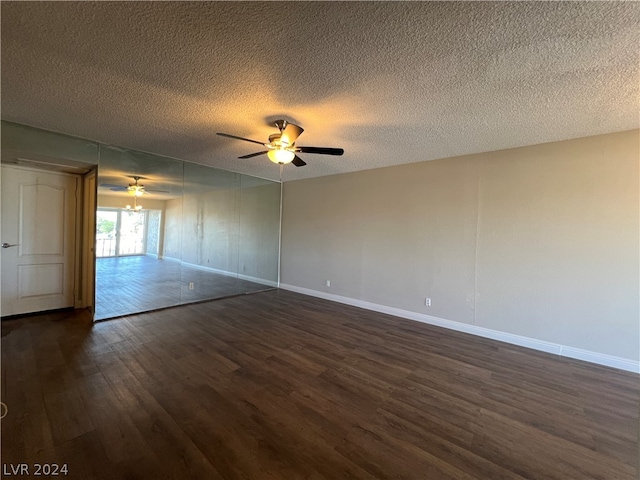 unfurnished room featuring dark hardwood / wood-style flooring, ceiling fan, and a textured ceiling