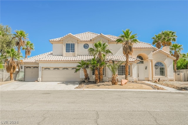 mediterranean / spanish-style house with a garage