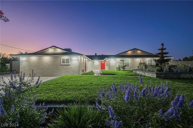 ranch-style house featuring a yard