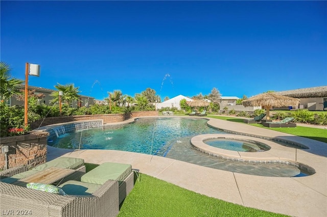 view of pool featuring an in ground hot tub and pool water feature