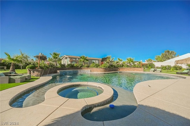 view of swimming pool with an in ground hot tub and pool water feature