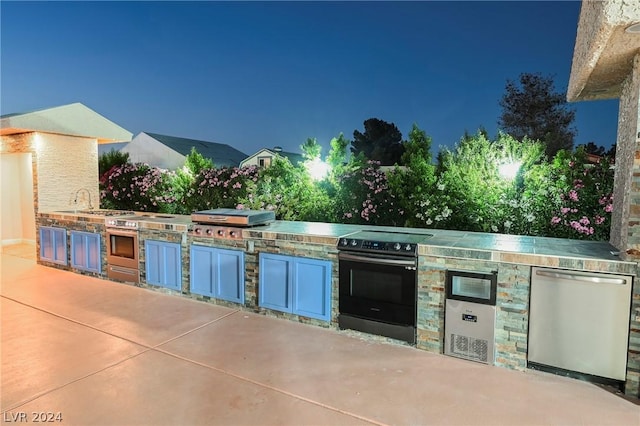 view of patio with an outdoor kitchen and area for grilling