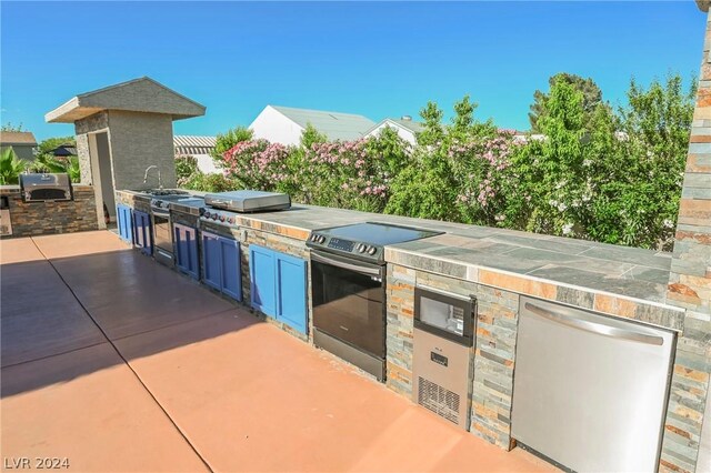 view of patio with grilling area and exterior kitchen