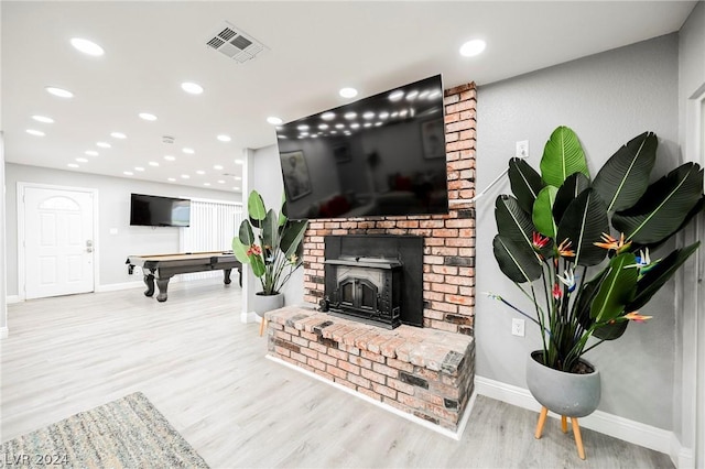 living room featuring light hardwood / wood-style flooring and pool table