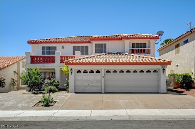 mediterranean / spanish house featuring a balcony and a garage