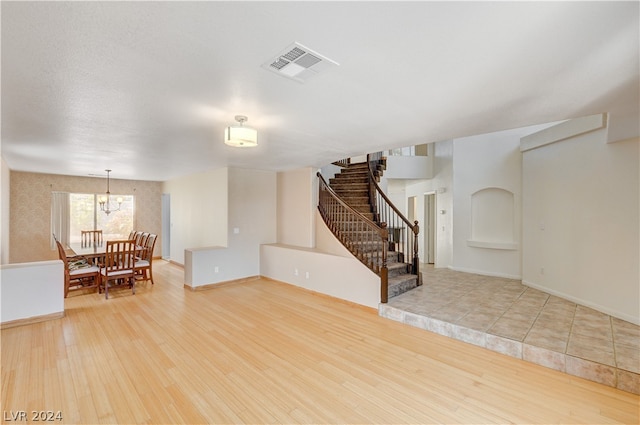 interior space featuring a chandelier and light hardwood / wood-style flooring