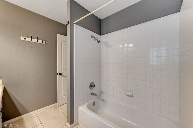 bathroom with tiled shower / bath combo and tile patterned floors