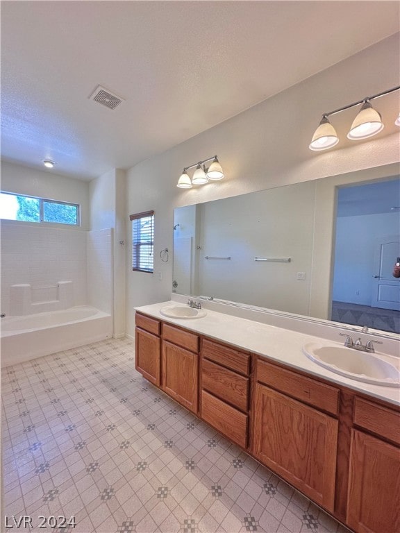 bathroom featuring tile flooring and dual vanity