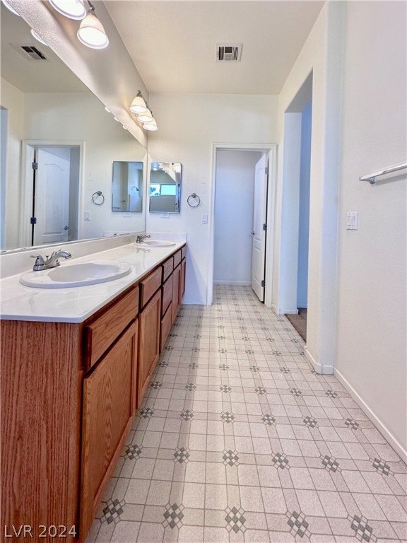 bathroom featuring tile flooring and double vanity