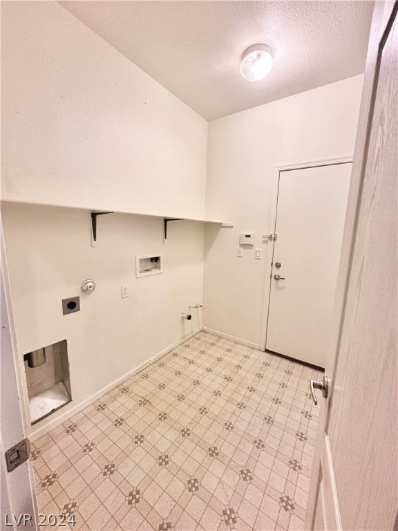 laundry area featuring gas dryer hookup, hookup for an electric dryer, light tile flooring, and washer hookup