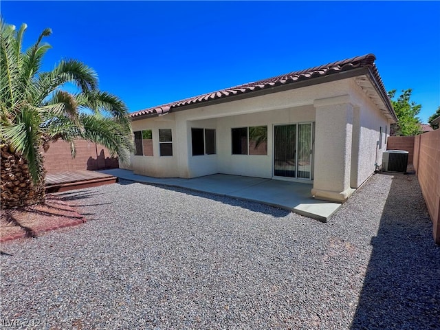 back of house featuring a wooden deck and central AC unit