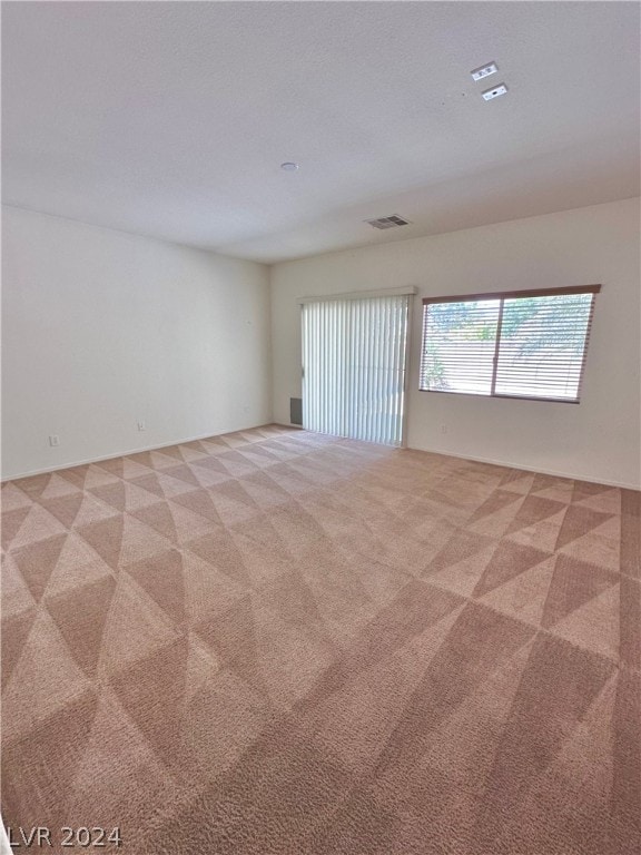 spare room featuring carpet