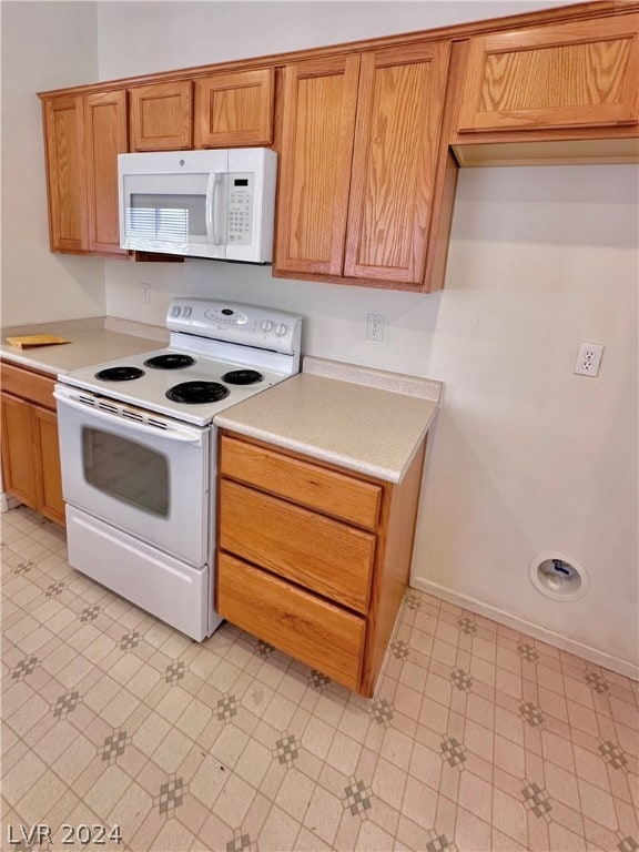 kitchen with light tile flooring and white appliances