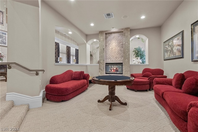 carpeted living room featuring a fireplace