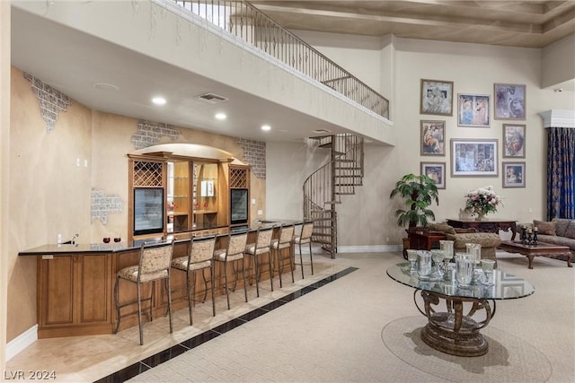 2785 S Monte Cristo Way, Las Vegas, NV 89117 - indoor wet bar with baseboards, stairway, a high ceiling, carpet flooring, and recessed lighting