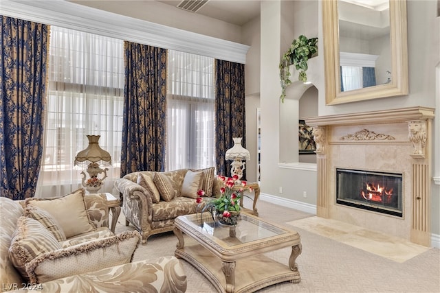 living room featuring a wealth of natural light, carpet flooring, and a fireplace