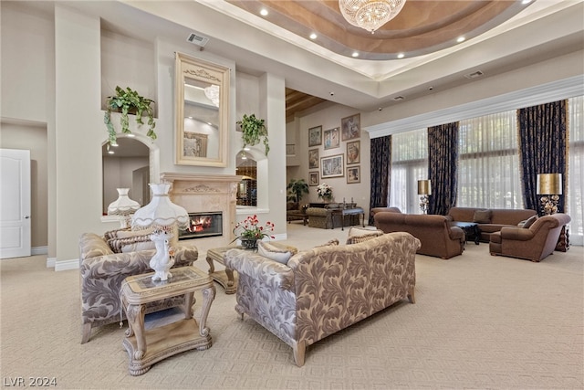 living room featuring a high ceiling, carpet, and a tray ceiling