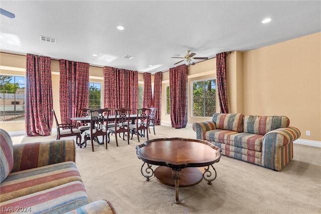 carpeted living room featuring ceiling fan