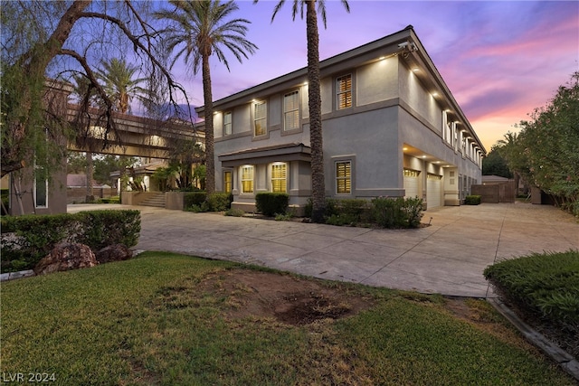 view of front of house featuring a garage and a yard