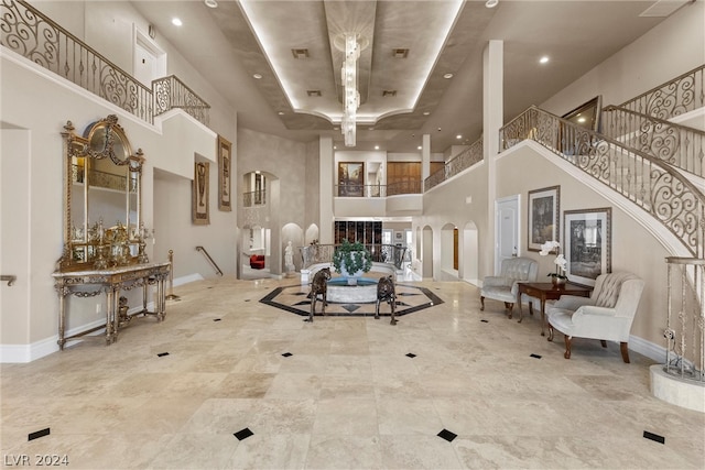 living room with a high ceiling and tile patterned floors