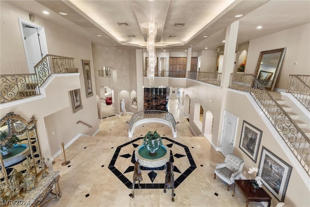 2785 S Monte Cristo Way, Las Vegas, NV 89117 - living room featuring a raised ceiling, recessed lighting, baseboards, a high ceiling, and stairs
